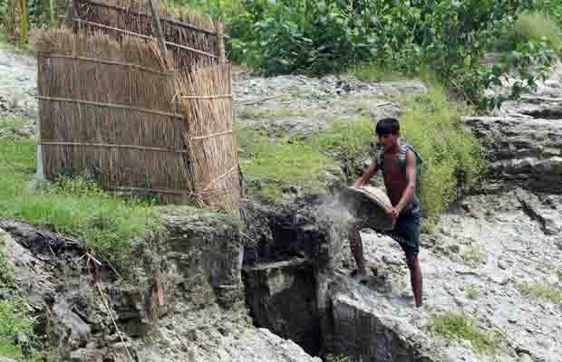 Participant fixing eroded latrine